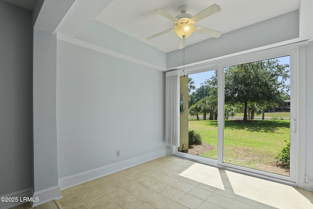 unfurnished room featuring light tile patterned flooring, baseboards, and a ceiling fan