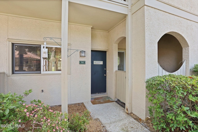 doorway to property with stucco siding