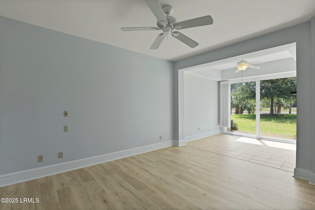 unfurnished room with light wood-style floors, ceiling fan, and baseboards