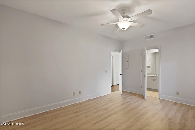 unfurnished bedroom with light wood-style floors, baseboards, ensuite bathroom, and ceiling fan