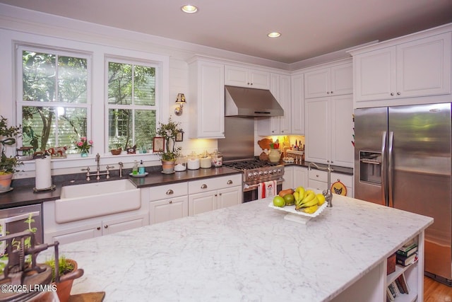 58 Wrights Point Cir, Beaufort, SC 29902 - kitchen featuring under cabinet range hood, appliances with stainless steel finishes, white cabinetry, dark stone counters, and recessed lighting