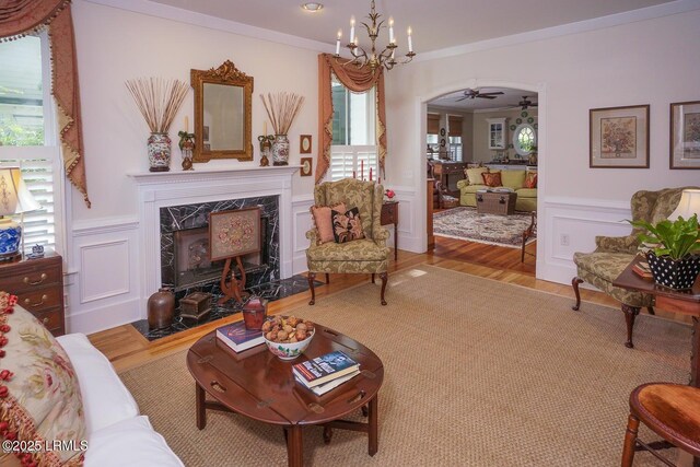 58 Wrights Point Cir, Beaufort, SC 29902 - living room featuring arched walkways, healthy amount of natural light, a premium fireplace, wood finished floors, and a wainscoted wall