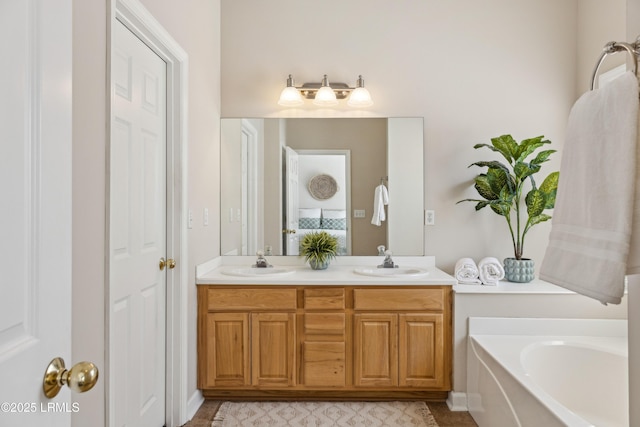 full bath with a sink, a garden tub, and double vanity