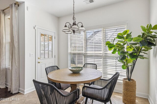 dining space featuring light tile patterned floors, visible vents, plenty of natural light, and an inviting chandelier