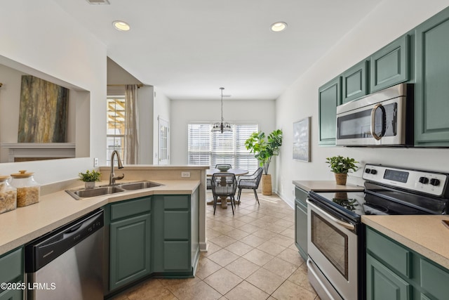 kitchen featuring a sink, appliances with stainless steel finishes, and green cabinets