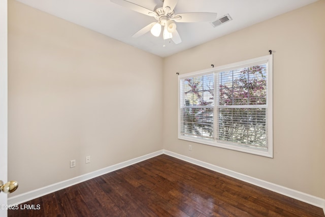 empty room with a ceiling fan, baseboards, visible vents, and dark wood-style flooring