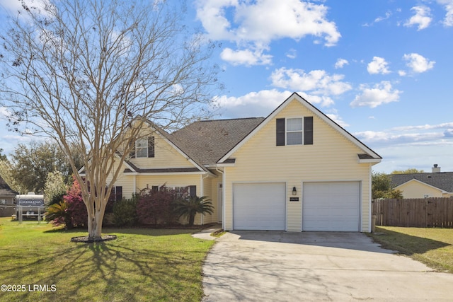 traditional-style house with a shingled roof, a front lawn, fence, concrete driveway, and an attached garage