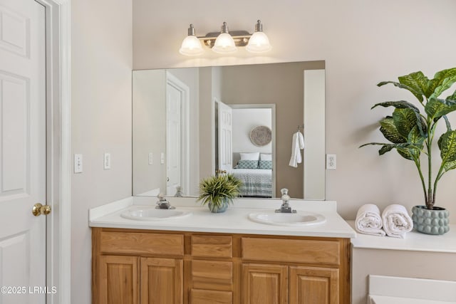 ensuite bathroom with double vanity, ensuite bathroom, and a sink