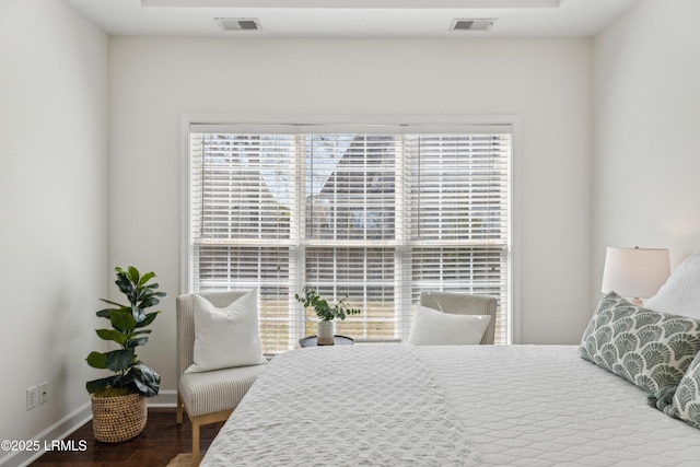 bedroom featuring visible vents, wood finished floors, and baseboards