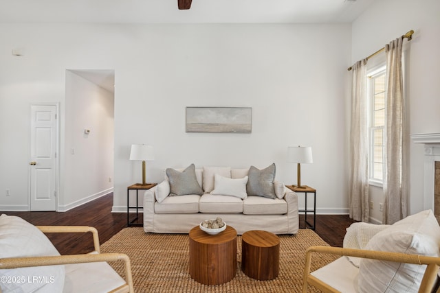 living area featuring baseboards and wood finished floors