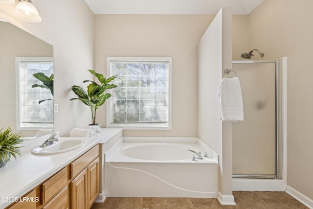 full bathroom featuring tile patterned flooring, a garden tub, vanity, and a stall shower