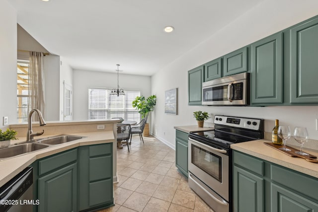 kitchen featuring a sink, green cabinets, and stainless steel appliances