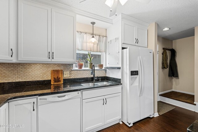 900 Brotherhood Rd Unit D2, Beaufort, SC 29902 - kitchen with backsplash, white appliances, white cabinetry, a sink, and dark wood-style floors