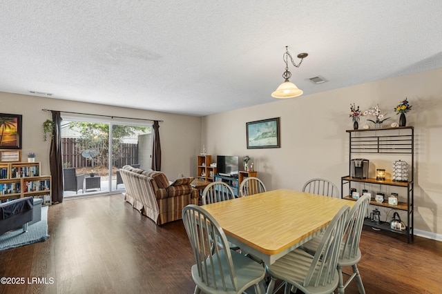 900 Brotherhood Rd Unit D2, Beaufort, SC 29902 - dining room featuring dark wood-type flooring, visible vents, and a textured ceiling