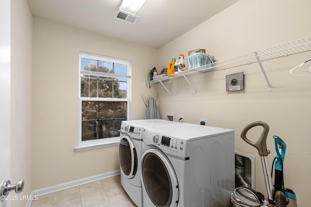 109 Patriot Ct, Beaufort, SC 29906 - washroom featuring washer and clothes dryer, baseboards, and light tile patterned flooring