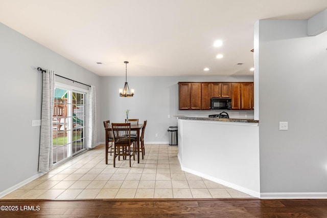 109 Patriot Ct, Beaufort, SC 29906 - kitchen with black microwave, recessed lighting, a chandelier, brown cabinets, and baseboards