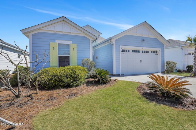 view of front of property featuring a garage, driveway, a front lawn, and board and batten siding