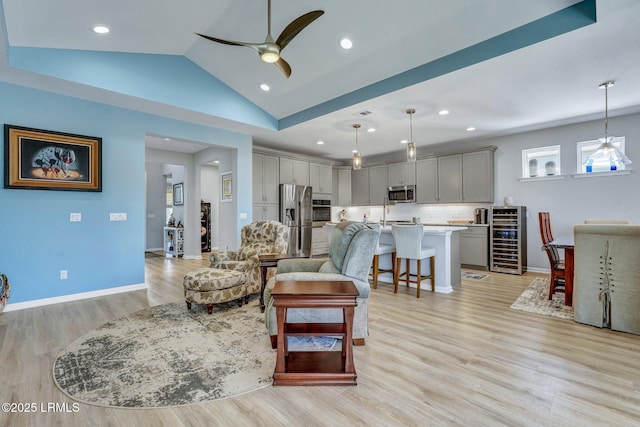 267 Cool Breeze Dr, Hardeeville, SC 29927 - living room with wine cooler, light wood-style flooring, a ceiling fan, baseboards, and vaulted ceiling