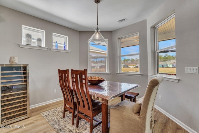267 Cool Breeze Dr, Hardeeville, SC 29927 - dining room with beverage cooler, baseboards, visible vents, and light wood-style floors