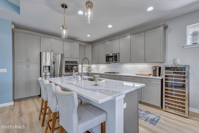 267 Cool Breeze Dr, Hardeeville, SC 29927 - kitchen featuring light stone counters, stainless steel appliances, gray cabinetry, a sink, and beverage cooler