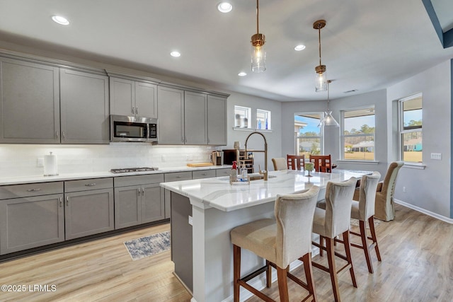 267 Cool Breeze Dr, Hardeeville, SC 29927 - kitchen with appliances with stainless steel finishes, backsplash, a sink, and gray cabinetry