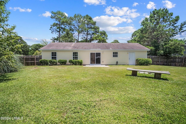 back of house with a patio area, a yard, and a fenced backyard