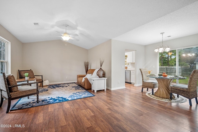 sitting room featuring a healthy amount of sunlight, wood finished floors, and ceiling fan with notable chandelier