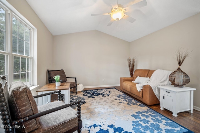 sitting room with dark wood finished floors, baseboards, ceiling fan, and vaulted ceiling