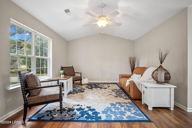 living area with wood finished floors, a ceiling fan, visible vents, baseboards, and lofted ceiling