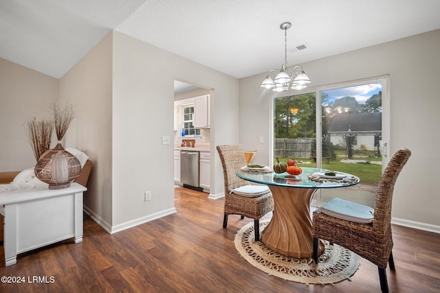 dining area featuring a notable chandelier, baseboards, visible vents, and wood finished floors