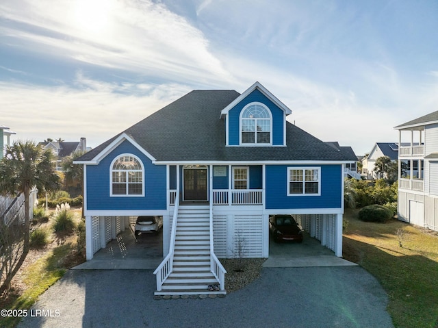 coastal home featuring a carport and a porch