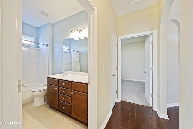 full bathroom featuring vanity, hardwood / wood-style floors, toilet, and shower / tub combo with curtain