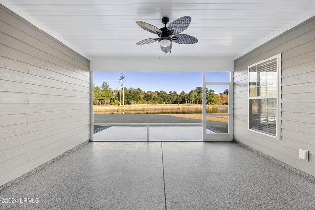 unfurnished sunroom featuring ceiling fan