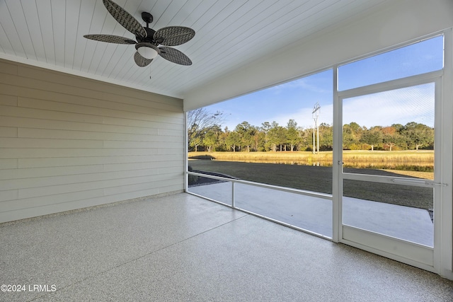 unfurnished sunroom with ceiling fan