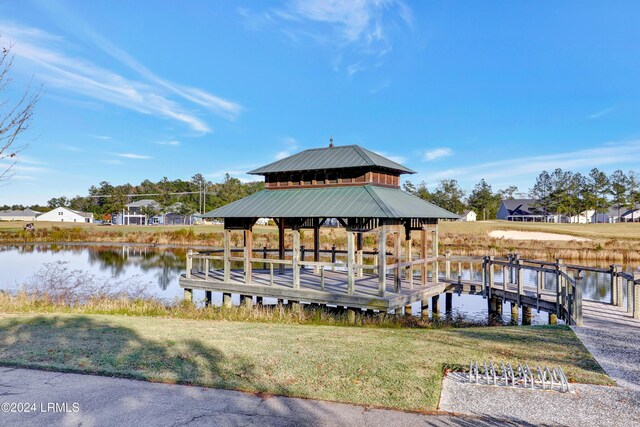 dock area featuring a gazebo, a lawn, and a water view