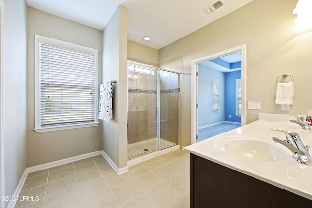 bathroom featuring vanity, tile patterned flooring, and a shower with door