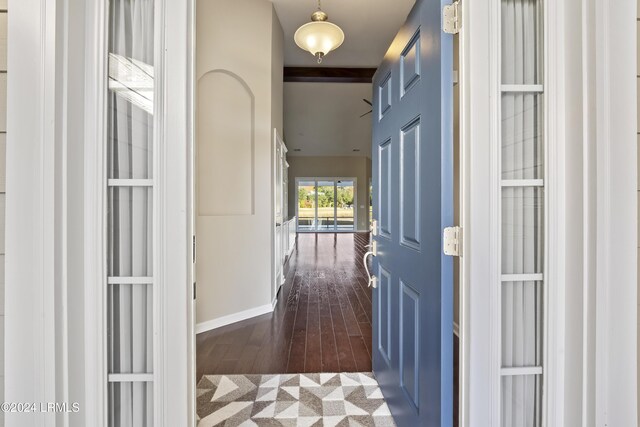 hall with dark wood-type flooring and beamed ceiling