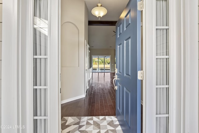 hall with dark wood-type flooring and beamed ceiling