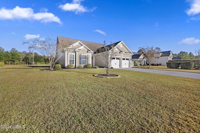 view of front of home featuring a garage and a front lawn