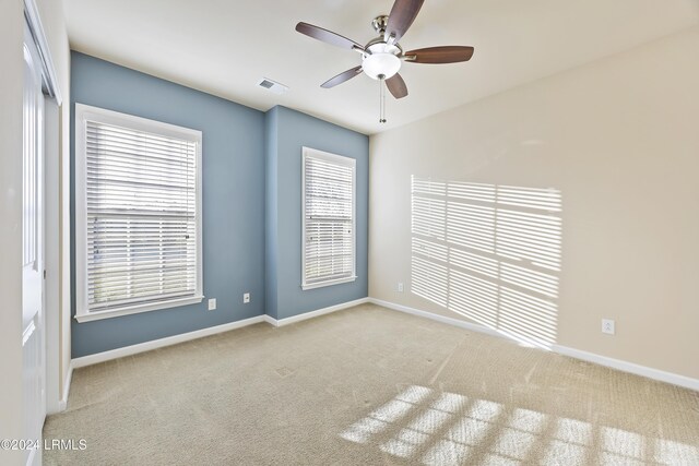 empty room with light colored carpet and ceiling fan