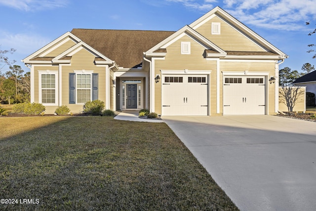 view of front of home with a garage and a front yard