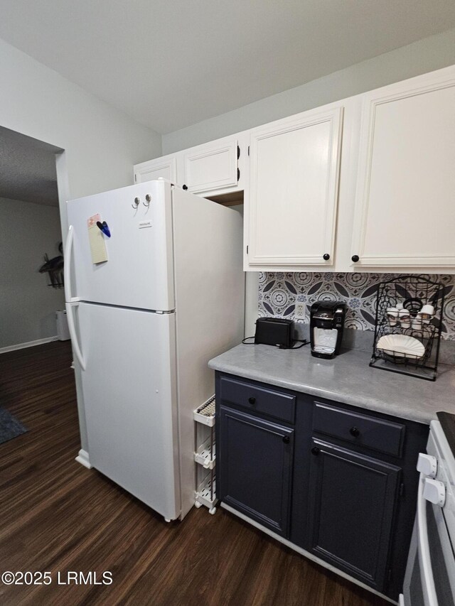 814 14th St, Port Royal, SC 29935 - kitchen with dark wood-style flooring, white appliances, light countertops, white cabinetry, and decorative backsplash