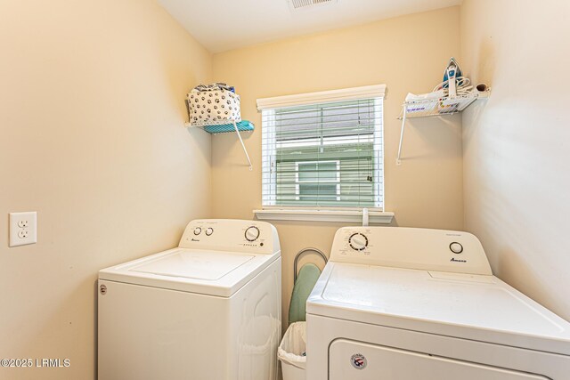 clothes washing area featuring washer and dryer, laundry area, and visible vents