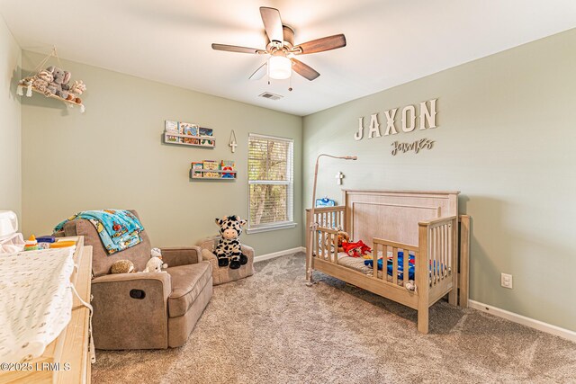 bedroom featuring visible vents, baseboards, a nursery area, and light colored carpet