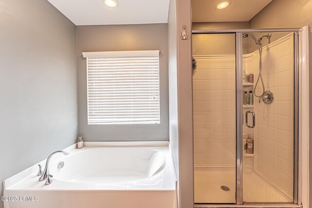 bathroom featuring a garden tub, recessed lighting, and a shower stall