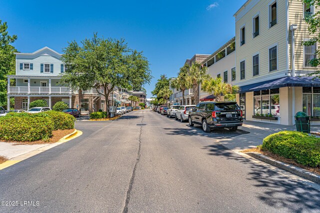 view of street featuring a residential view and curbs