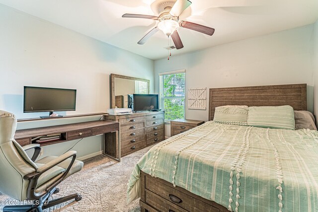 bedroom with light carpet, a ceiling fan, and visible vents