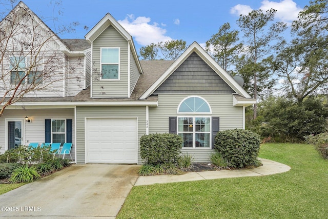 view of front of house featuring a garage and a front lawn