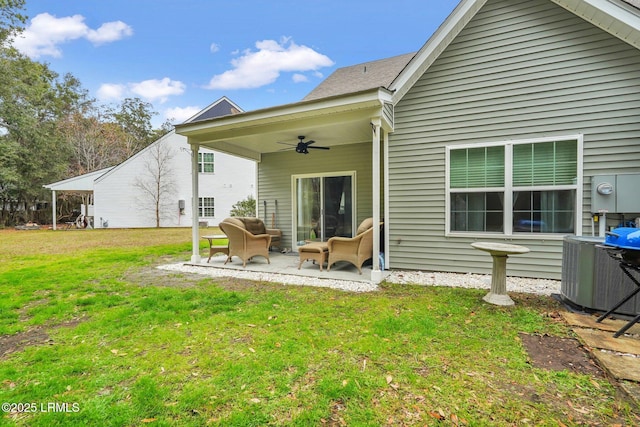 back of house featuring a patio, cooling unit, ceiling fan, and a lawn