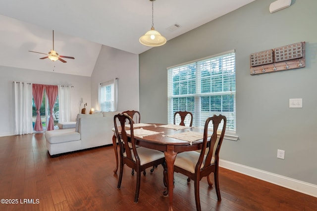 dining space featuring a wealth of natural light, dark hardwood / wood-style floors, and vaulted ceiling